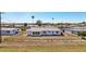 Exterior view of a one-story home with fenced yard and palm trees at 1021 Augusta Dr, Sun City Center, FL 33573