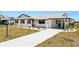 This single-story home offers a spacious driveway, well-maintained lawn, and a freshly painted exterior with dark trim at 1021 Augusta Dr, Sun City Center, FL 33573