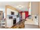 Bright kitchen featuring white cabinetry, stainless steel appliances, and stylish backsplash and wood floors at 1021 Augusta Dr, Sun City Center, FL 33573