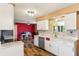 Bright kitchen with white cabinetry, stone countertops, stainless steel appliances, and wood-look flooring at 1021 Augusta Dr, Sun City Center, FL 33573