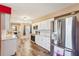 Bright kitchen featuring stainless steel appliances, ample white cabinetry, and wood-look flooring at 1021 Augusta Dr, Sun City Center, FL 33573