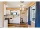 Bright kitchen with white cabinetry, stone countertops, stainless steel appliances, and wood-look flooring at 1021 Augusta Dr, Sun City Center, FL 33573