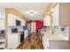 Bright kitchen featuring white cabinetry, stainless steel appliances, and stylish backsplash and wood floors at 1021 Augusta Dr, Sun City Center, FL 33573