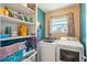 Functional laundry room with ample storage shelves, modern washer, and dryer units at 1021 Augusta Dr, Sun City Center, FL 33573