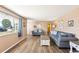 Bright living room with hardwood floors, cozy sofas, and ample natural light creating a comfortable living space at 1021 Augusta Dr, Sun City Center, FL 33573