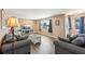 Comfortable living room with hardwood floors, plush seating, and a wall-mounted TV for entertainment at 1021 Augusta Dr, Sun City Center, FL 33573