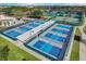 Aerial view of community pickleball courts with players and green surroundings at 1021 Augusta Dr, Sun City Center, FL 33573