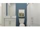 Stylish bathroom featuring white subway tile, a framed picture, a toilet, and a vanity with bright marble counters at 10301 Gentle Rain Dr, Land O Lakes, FL 34638