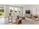 Bright and airy living room with contemporary furnishings, stylish decor, and large windows offering scenic views at 10559 Farm Hill Ave, Land O Lakes, FL 34638