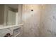 Shower featuring marble tile and built in toiletry cubby at 10640 Crescent Creek Xing, Parrish, FL 34219