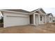 Beautiful single-story home with an attached garage and covered porch, showcasing modern architectural design at 10640 Crescent Creek Xing, Parrish, FL 34219
