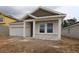 Charming single-story home featuring stucco siding, a two-car garage, and a welcoming front porch at 10640 Crescent Creek Xing, Parrish, FL 34219