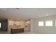 Modern kitchen features white cabinets, spacious center island, and stainless steel sink and faucet at 10640 Crescent Creek Xing, Parrish, FL 34219