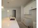 Modern kitchen features white cabinets, spacious center island, and stainless steel sink and faucet at 10640 Crescent Creek Xing, Parrish, FL 34219
