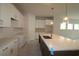 Modern kitchen features white cabinets, spacious center island, and stainless steel sink and faucet at 10640 Crescent Creek Xing, Parrish, FL 34219
