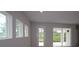 Bright living room boasts natural light through multiple windows and sliding glass door at 10640 Crescent Creek Xing, Parrish, FL 34219