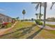 Lush backyard landscaping and brick-lined gardens provide a beautiful transition to the peaceful lake setting at 1123 Signature Dr, Sun City Center, FL 33573