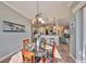 Dining area featuring a chandelier and a view into the kitchen and living spaces at 1123 Signature Dr, Sun City Center, FL 33573