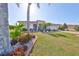 Charming single-story home with a well-manicured lawn, lush landscaping, and a beautiful red tile roof at 1123 Signature Dr, Sun City Center, FL 33573