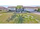 Beautifully landscaped front yard with a well-maintained lawn, colorful plantings, and a charming single-story home at 1123 Signature Dr, Sun City Center, FL 33573