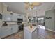 Charming kitchen with stone tile flooring, stainless steel appliances, and views into the dining room at 1123 Signature Dr, Sun City Center, FL 33573