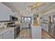 Well-equipped kitchen with stainless steel appliances, tile floors, and ample counter space at 1123 Signature Dr, Sun City Center, FL 33573