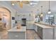 Charming kitchen with light cabinets, tile floors, stainless steel appliances, and ample counter space at 1123 Signature Dr, Sun City Center, FL 33573