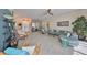 Bright, open living room with tile floors, comfortable seating, and stylish decor and fixtures at 1123 Signature Dr, Sun City Center, FL 33573