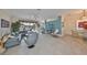 Open-concept living area with neutral tones, tile flooring, and comfortable sectional couch at 1123 Signature Dr, Sun City Center, FL 33573