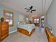 Bedroom featuring a ceiling fan, shuttered windows, and a neutral color scheme at 1123 Signature Dr, Sun City Center, FL 33573
