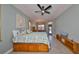 Spacious bedroom with a ceiling fan, tiled floor, and an abundance of natural light at 1123 Signature Dr, Sun City Center, FL 33573