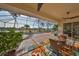 Inviting screened patio with ceiling fans overlooks lake, offering a perfect spot for relaxation and outdoor dining at 1123 Signature Dr, Sun City Center, FL 33573