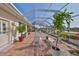 Large screened patio features brick flooring and lake views, creating a serene outdoor living space with room to enjoy at 1123 Signature Dr, Sun City Center, FL 33573