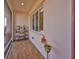 Screened-in front porch with brick flooring, plants and window with shade at 1123 Signature Dr, Sun City Center, FL 33573