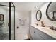 Bathroom with a double sink vanity with granite countertop and modern fixtures, adjacent to the glass shower at 11650 Capri S Cir # 203, Treasure Island, FL 33706