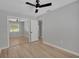 A bedroom featuring hardwood floors, a ceiling fan, and a closet with sliding mirror doors at 1235 14Th N St, St Petersburg, FL 33705