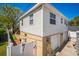 Two-story home with vinyl siding, three-car garage, and well-maintained yard with white fence at 1235 14Th N St, St Petersburg, FL 33705