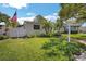 Charming single-story home with manicured lawn, white picket fence, and lush landscaping at 1235 14Th N St, St Petersburg, FL 33705