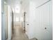 Bright hallway with light wood-look tile flooring, white trim and doors, and storage cabinets at 1235 14Th N St, St Petersburg, FL 33705