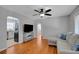 Inviting living room with hardwood floors, ceiling fan, and view of kitchen through arched doorway at 1235 14Th N St, St Petersburg, FL 33705