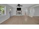 Spacious living room with fireplace, ceiling fan, and hardwood flooring at 1235 14Th N St, St Petersburg, FL 33705
