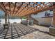 Paver patio features a wooden pergola, hot tub, and stairs leading to an elevated portion of the home at 1235 14Th N St, St Petersburg, FL 33705