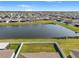 Aerial view of pond with homes in a Gathering-friendly neighborhood at 13538 Willow Bluestar Loop, Riverview, FL 33579
