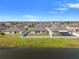 Aerial view of a meticulously kept backyard with a serene water view and a white picket fence at 13538 Willow Bluestar Loop, Riverview, FL 33579