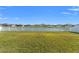 Lush backyard with a serene pond view, enclosed by a pristine white fence at 13538 Willow Bluestar Loop, Riverview, FL 33579