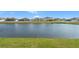 Backyard view of a pond and various homes in a serene neighborhood at 13538 Willow Bluestar Loop, Riverview, FL 33579
