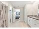 Well-lit bathroom offers a granite-topped vanity and leads to bedroom and water closet for convenience at 13538 Willow Bluestar Loop, Riverview, FL 33579