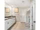 Bright bathroom featuring double sinks, granite countertops, and a separate shower room for convenience at 13538 Willow Bluestar Loop, Riverview, FL 33579
