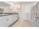 Bathroom featuring double sinks with granite counters and modern white cabinets and neutral walls at 13538 Willow Bluestar Loop, Riverview, FL 33579