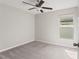Neutral bedroom features a ceiling fan, carpet floors and a window with natural light at 13538 Willow Bluestar Loop, Riverview, FL 33579